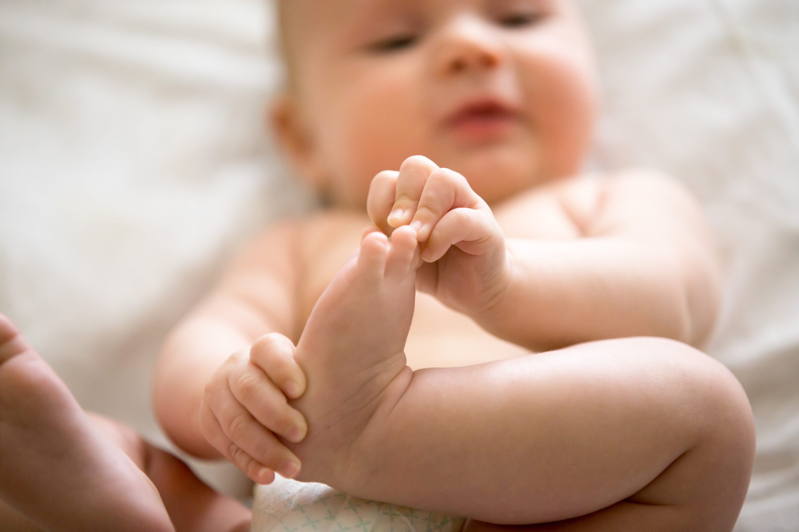 Adorable baby taking an interest in his feet